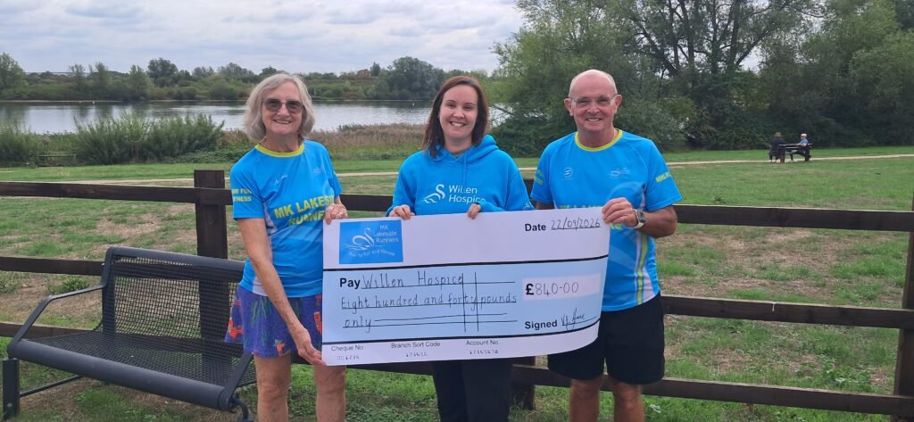Val and Mick handing over the cheque with funds raised by a sponsored Zipwire at Penryhn Quarry, Wales